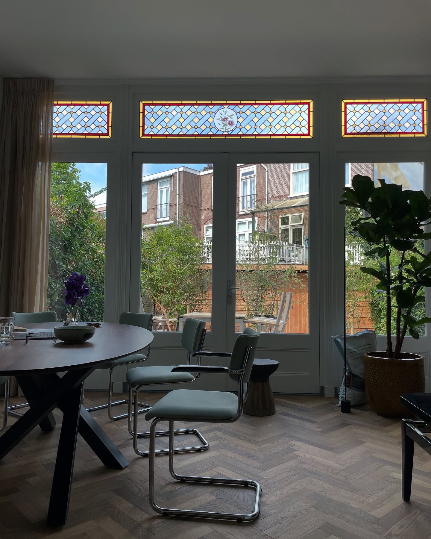 Eetkamer met drie bovenlichten boven openslaande deuren